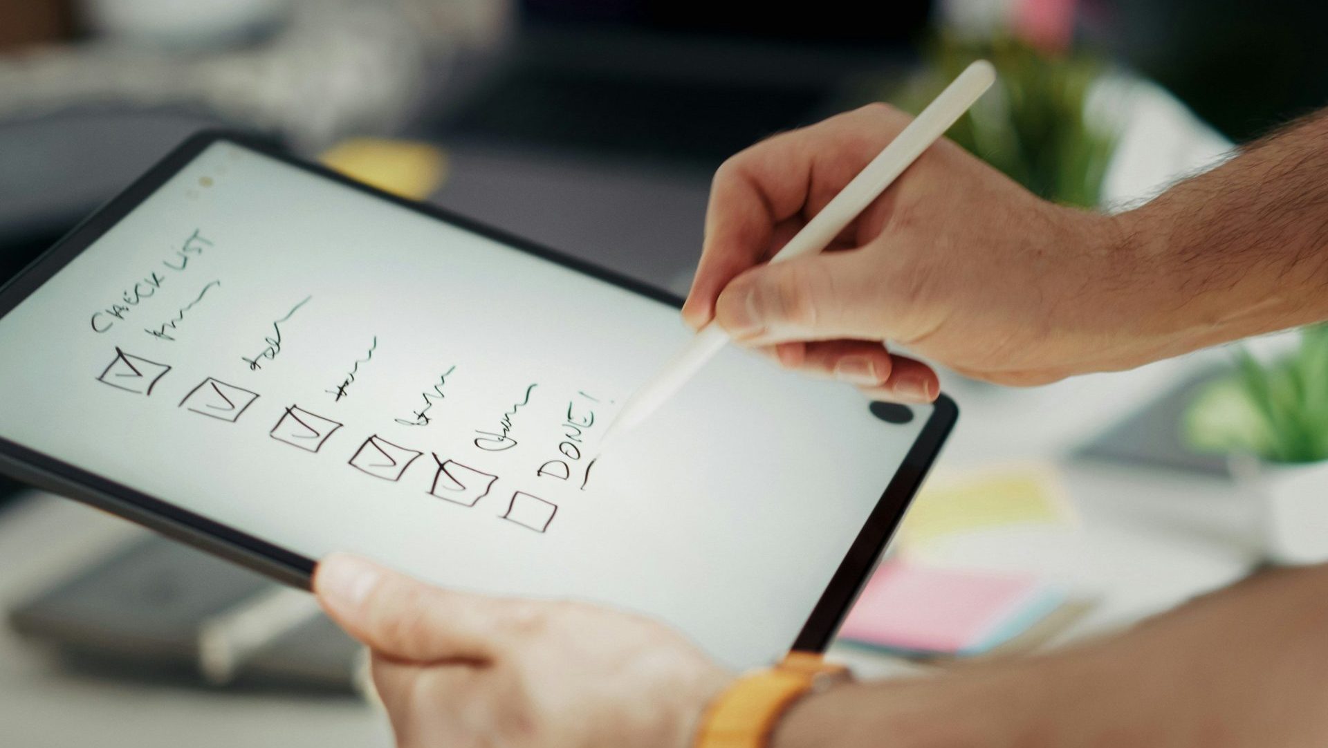 Writing on a checklist with a stylus.